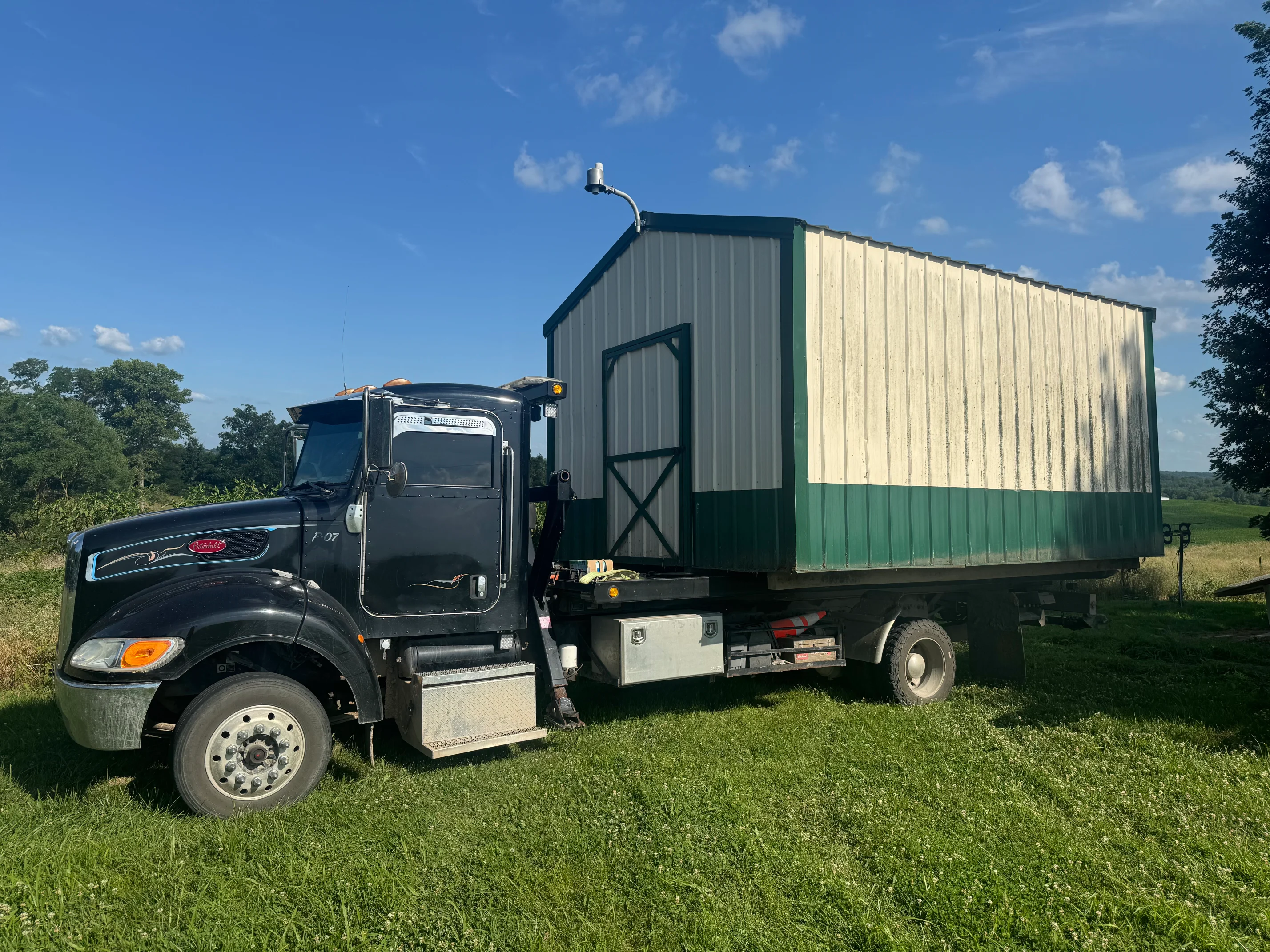 Equipment loaded on rollback trailer